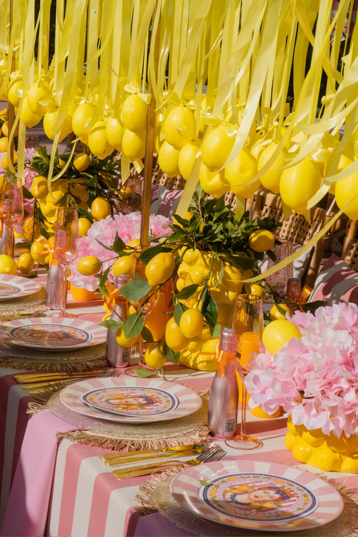 Styled tablescape with hanging lemons and pink hydrangeas